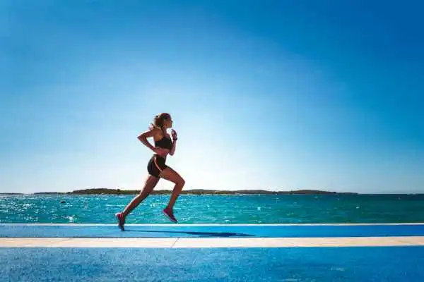 Woman running showing strong leg muscle Southall